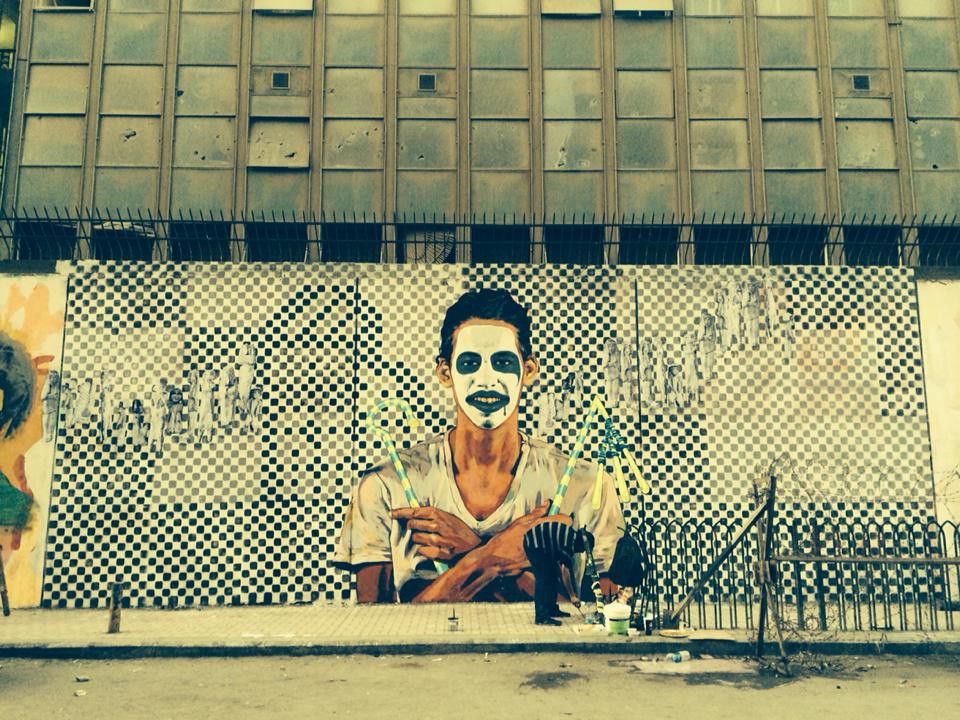 Surrounded by Ushabti figures, the young artist Hisham Rizk is remembered in a mural on Mohamed Mahmoud Street near Tahrir Square. This friend of Ammar was found dead in July 2014. © Sara M Shady